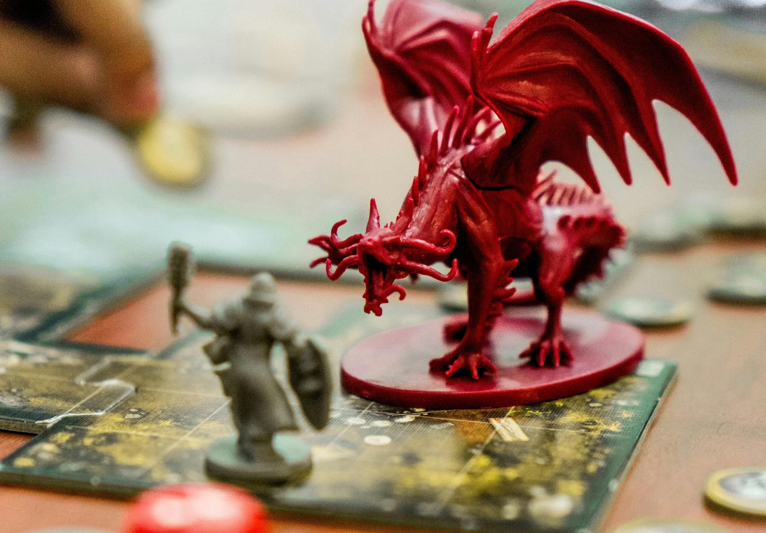 A red dragon figure roaring at a player's character piece.