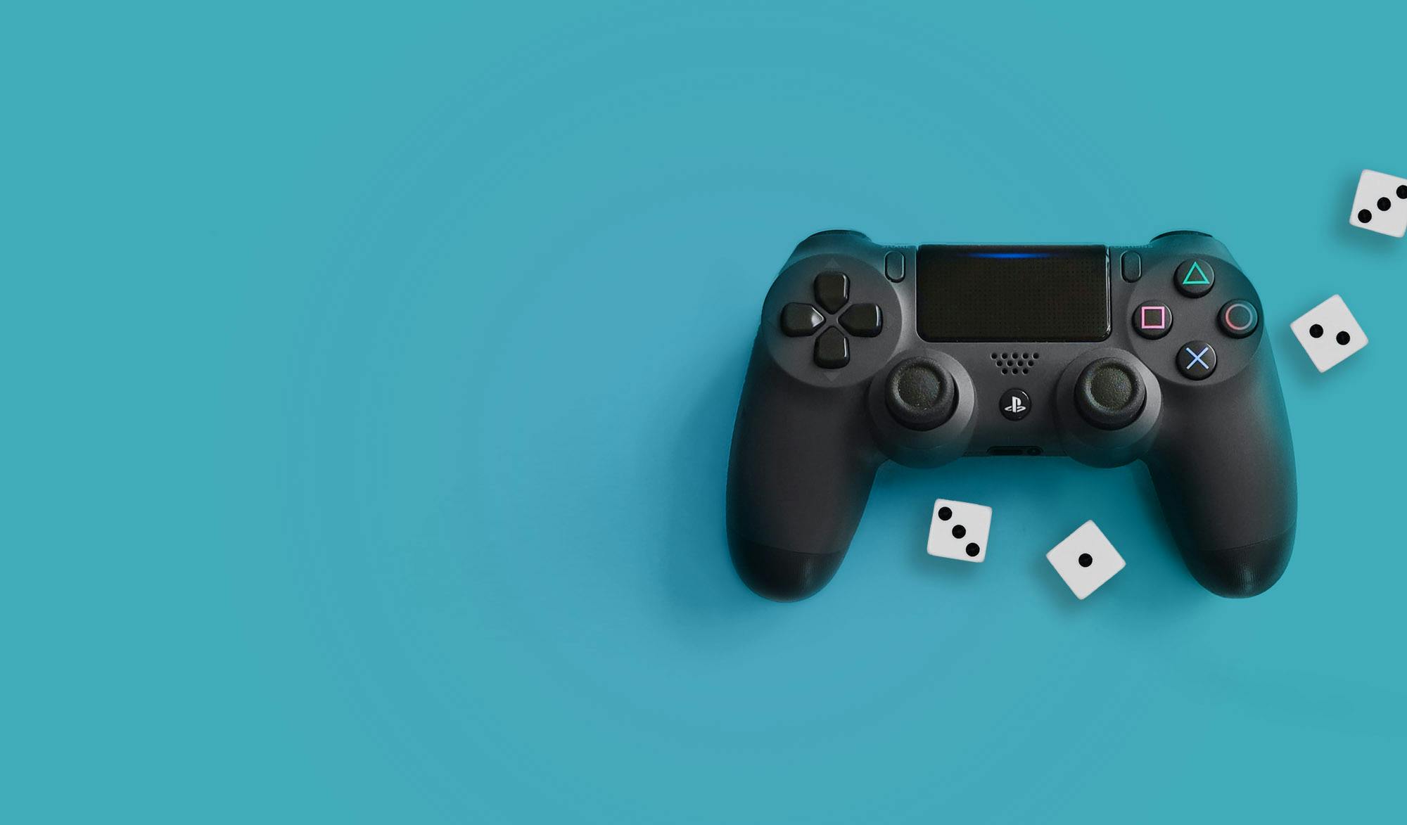 A PlayStation games controller and two white dice