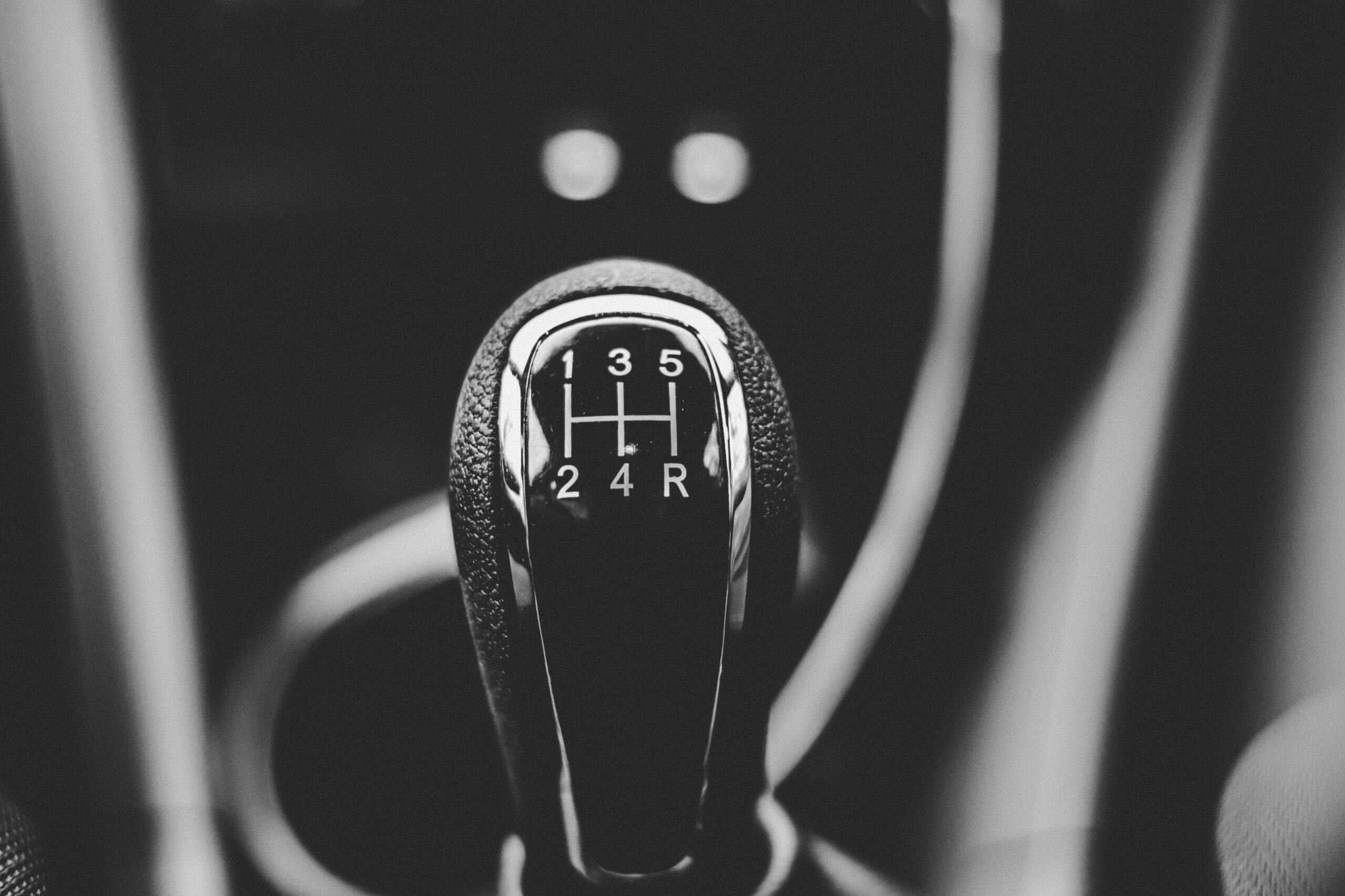 Close up of a manual gear stick with five gears.