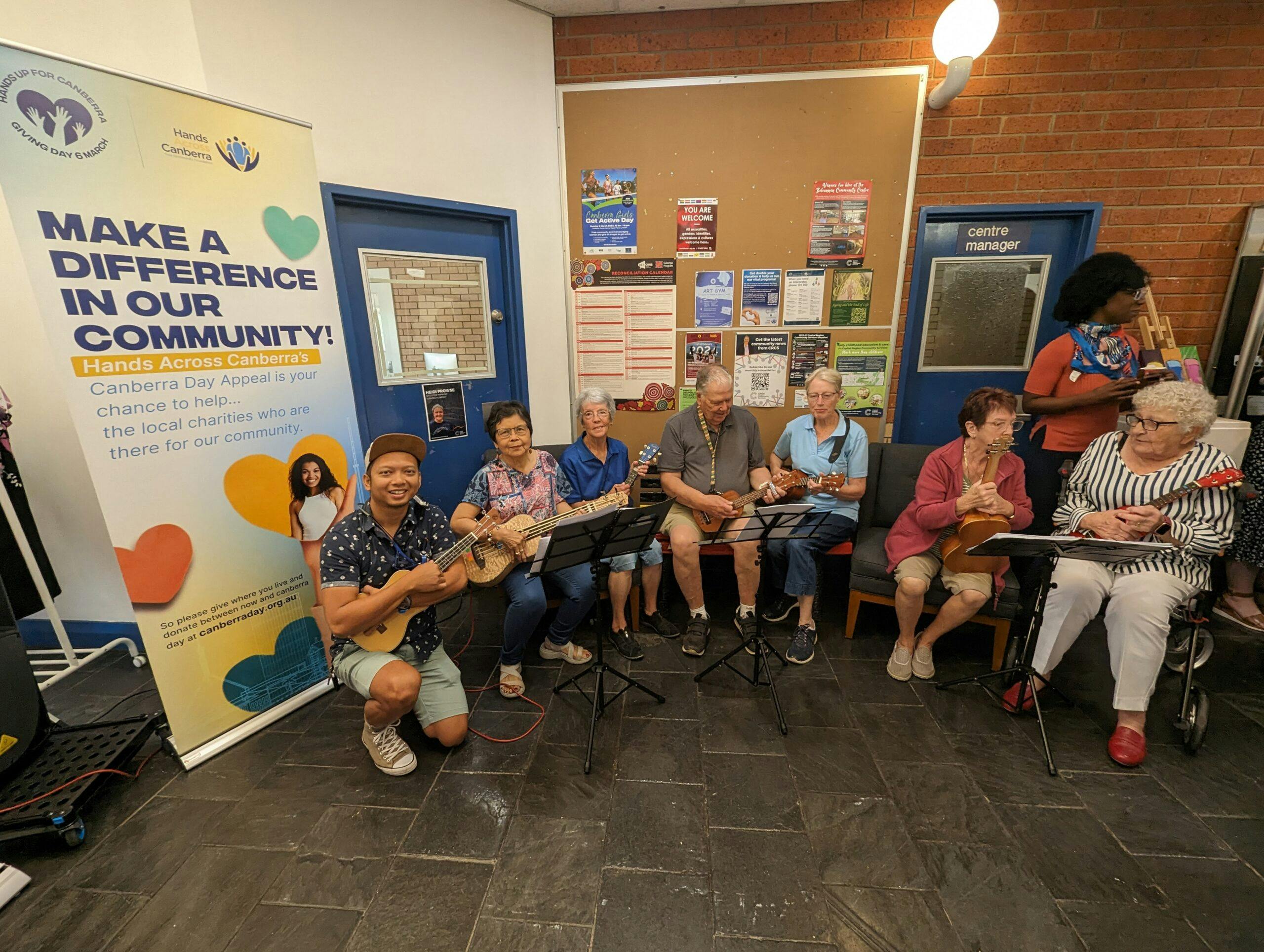 The Involve team takes a group photo with their ukuleles in hand.