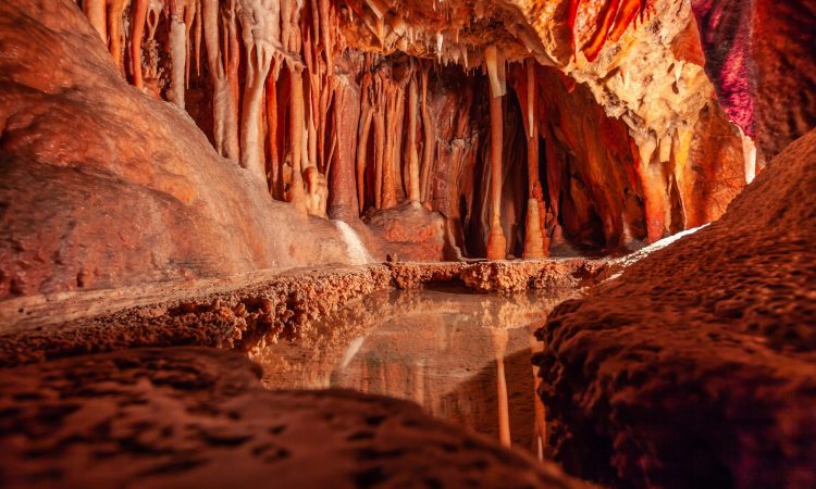 Stalactites and water pond in a limestone cave in Australia